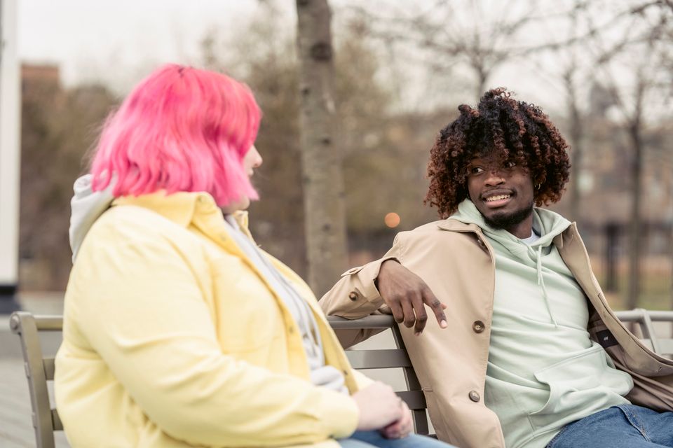 Two friends laughing together outdoors