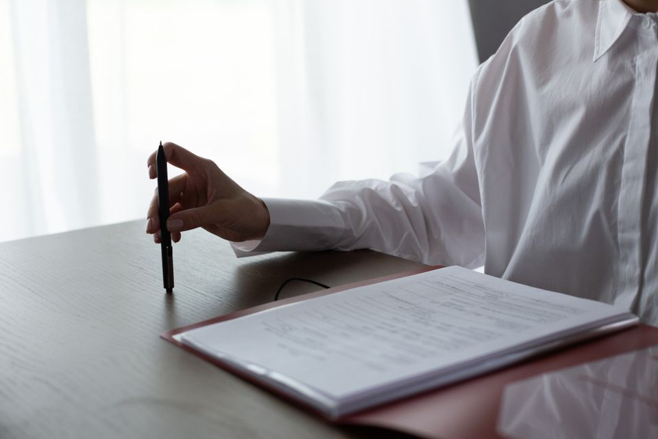 Woman calmly reviewing insurance documents at a table